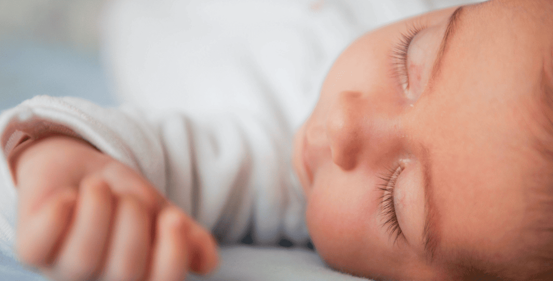 Bebê dormindo tranquilamente em berço, com hábitos para sono tranquilo